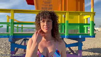 Curly haired MILF engages in sexual encounter with unknown man at the beach